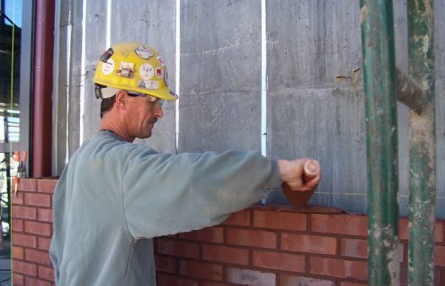 bricklayer laying bricks