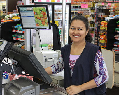 Grocery store worker at cash register