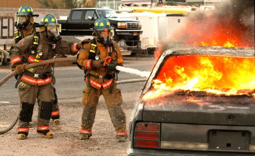 Firefighters putting out car fire